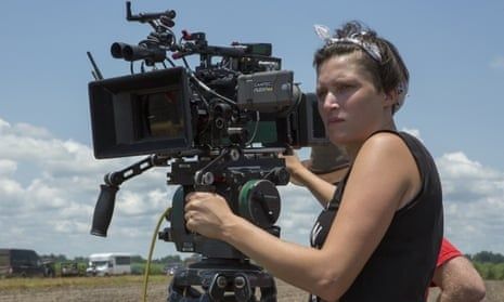 Cinematographer operating a professional camera outdoors on a film set